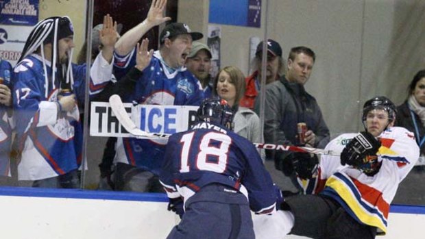 Melbourne's Glen Mayer crashes into Adelaide's Cassian Delsar during last night's Australian Ice Hockey League game.