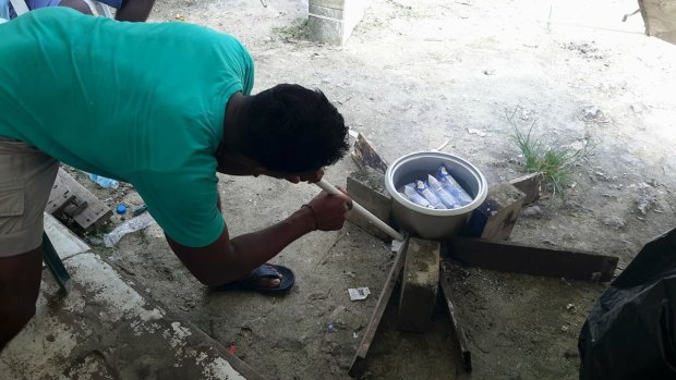 Men purportedly making tea inside the now-closed Manus Island regional processing facility, as a standoff with authorities continues.