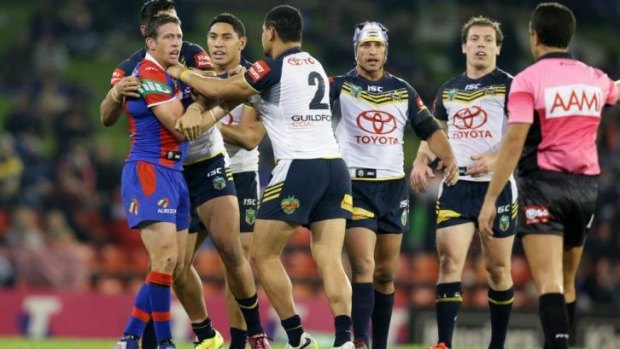 Fight Knight: Newcastle skipper Kurt Gidley gets to grips with Cowboys winger Matthew Wright.