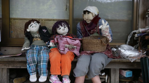Hand-made dolls sit outside an abandoned house as others are placed around the village by local resident Tsukimi Ayano to replace the dwindling local population in Nagoro village, in Miyoshi, Japan.