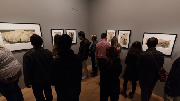 Crowds mill inside the Vincent van Gogh exhibition at the National Gallery of Victoria. 