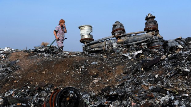 A woman walking among the wreckage of the MH17 crash site last week. 