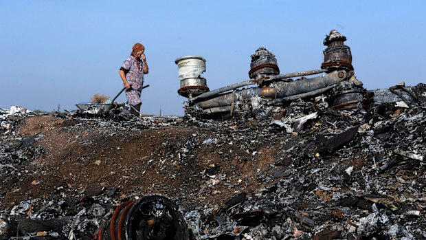 A woman walking among the wreckage of the MH17 crash site last week. 