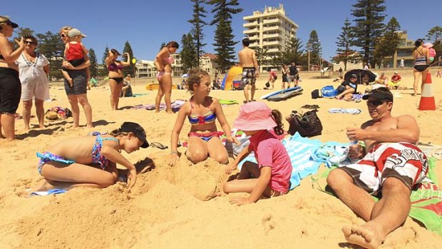 Summer sting ... the Duggan family are in Manly on holiday.