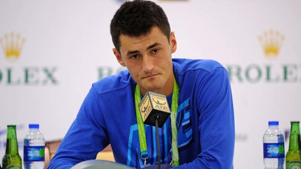 Bernard Tomic speaks to the media after his defeat.