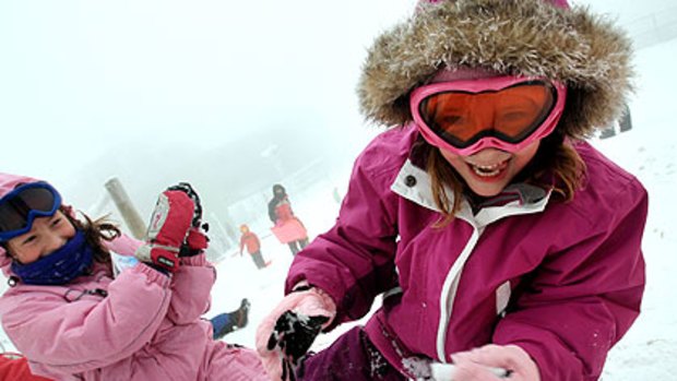 Jessie, 6, right and Eloise, 7, enjoy a cold start to the school holidays in the snow at Mount Buller.