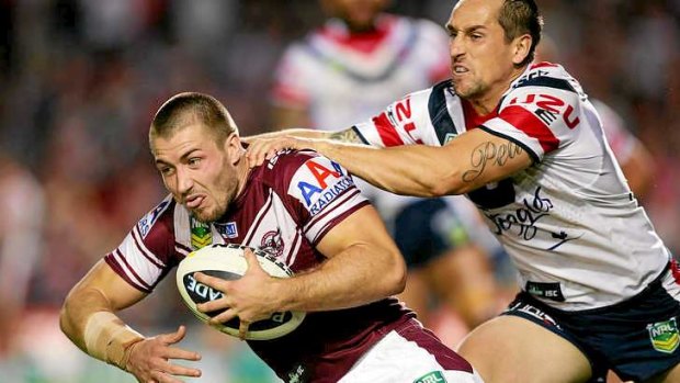 Kieran Foran is tackled by Mitchell Pearce of the Roosters.