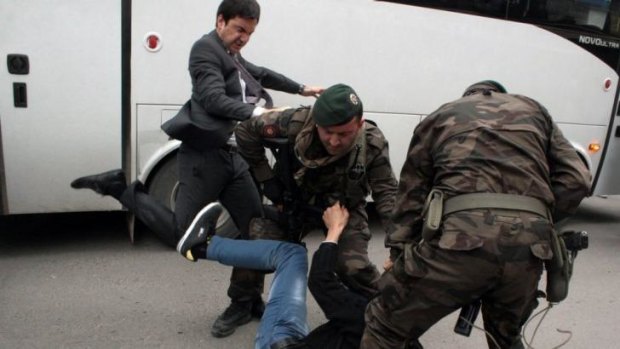 An advisor to Turkish Prime Minister Recep Tayyip Erdogan kicking the protester.