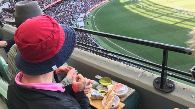 A man who sent social media into meltdown by feasting on an extravagant cheese platter while watching an AFL match at the MCG has broken his silence.