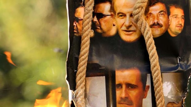 Call for change ... a makeshift gallows shows the pictures of former Syrian president Hafez al-Assd (top centre), his sons, current President Bashar al-Assad (second left and bottom centre) and Maher, left, their brother in-law General Assef Shawkat, second right, and businessman Rami Makhluf, right.