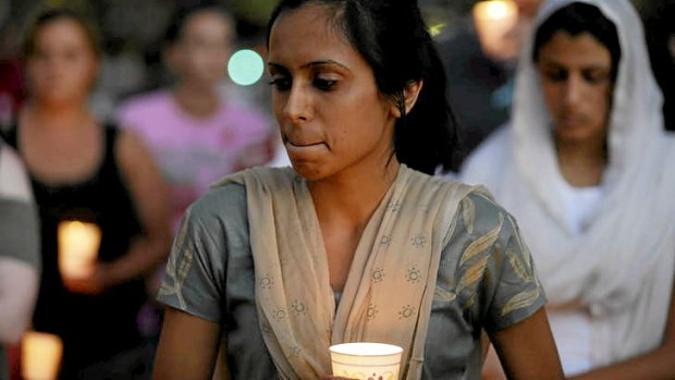 Mourners take part in a candlelight vigil for the victims of the shooting.