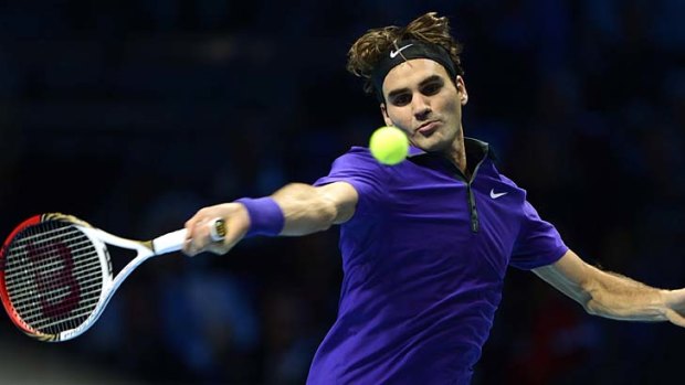 Roger Federer hits a return to Janko Tipsarevic.