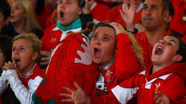 Tense ... Welsh fans react as they watch on a giant screen at Millennium Stadium.