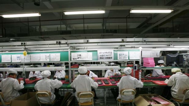 Workers on the production line inside a Foxconn factory in the township of Longhua.
