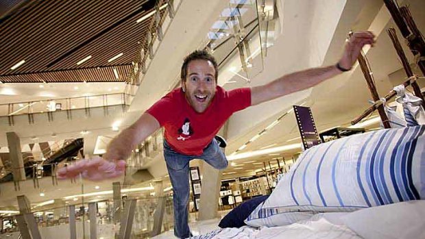 Adam Rozenbachs jumps at a Myer bedding display.