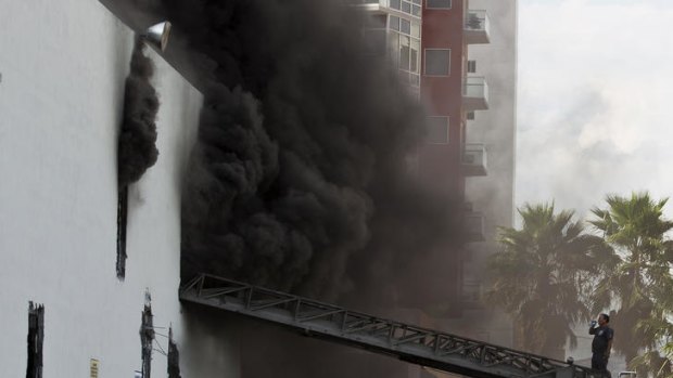 Smoke billows from the Casino Royale in Monterrey, Mexico after it was torched by gunmen.