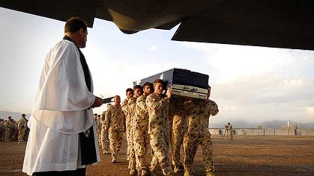 The coffin containing Corporal Mathew Hopkins’ body is loaded onto an RAAF Hercules for the flight to Australia.