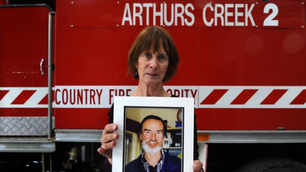 Grieving: Dini Shepherd holds a picture of her husband Joe. The CFA is  investigating whether he died in the line of duty.