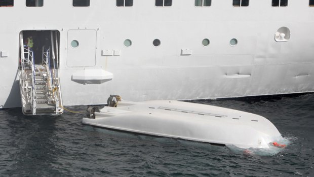A lifeboat remains in the sea after falling from a cruise liner killing 5 people during a safety drill while it was docked at La Palma in the Canary Islands on February 10, 2013.