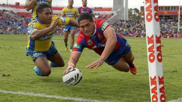 Rookie on the fly: Knights youngster Sione Mata'utai scores against Parramatta.