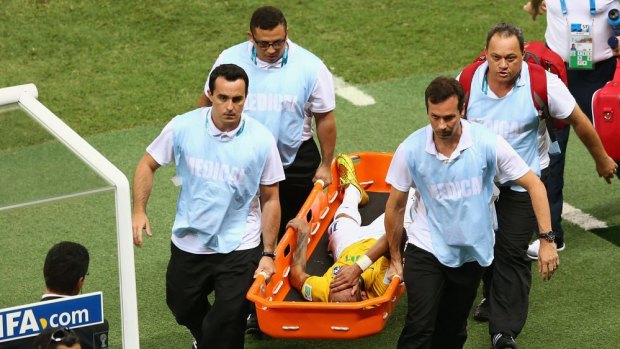 Brazil blow: Neymar is carried off on a stretcher.