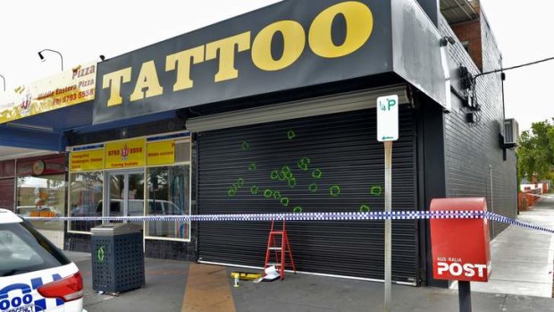 Police investigate the scene of overnight shootings at a tattoo parlour on Gladstone Road, Dandenong.
