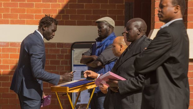 AFL footballer Majak Daw attends the funeral for for Bol, Anger and Madit.
