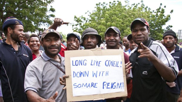 Protesters hold a placard during a friendly demonstration in Port Moresby this week.