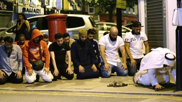 Local people observe prayers at Finsbury Park after a vehicle struck pedestrians.