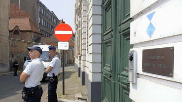 Police officers stand in front of one of the entrances of the archdiocese of Brussels-Malines, just north of the Belgian capital.
