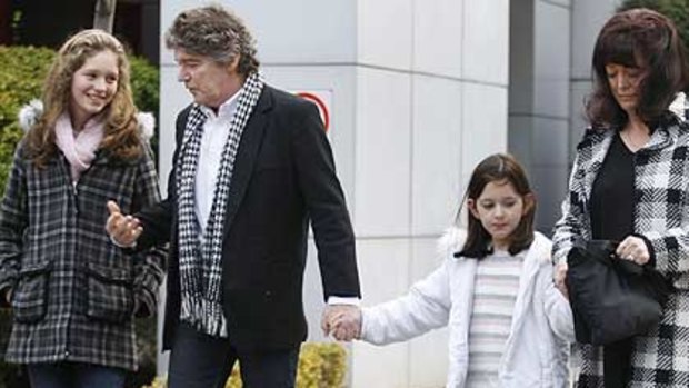 Jim Keays and wife Karin outside of Coroners Court, with daughters Holly, 12  and Bonnie, 6 after the finding on their son's death.