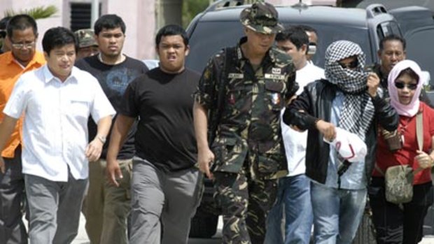 Andal Ampatuan, second right, gives himself up.