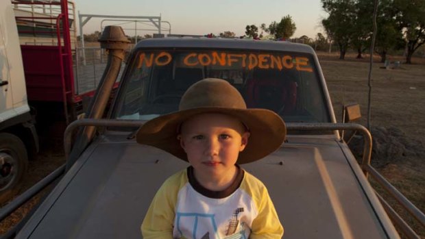 On the road &#8230; Harrison Phillips, on the bonnet of his father's ute, joins the protest at Katherine yesterday.