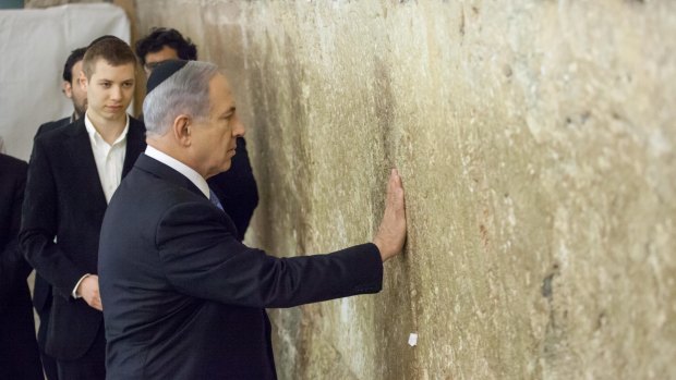 Mr Netanyahu prays at the tunnel section of the Western Wall in Jerusalem on Wednesday after his election victory.