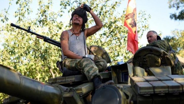 Pro-Russian fighters sit on top of their T-64 tank in Starobesheve, south-east of Donetsk.