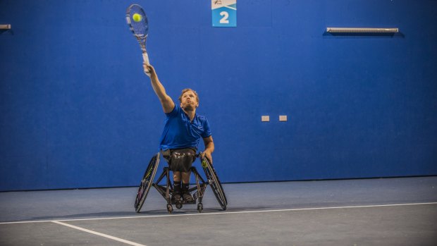 Dylan Alcott is in action on the tennis court on day two.