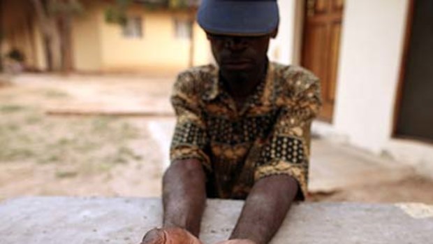 An illegal diamond dealer from Zimbabwe displays diamonds for sale in Manica, near the border with Zimbabwe.
