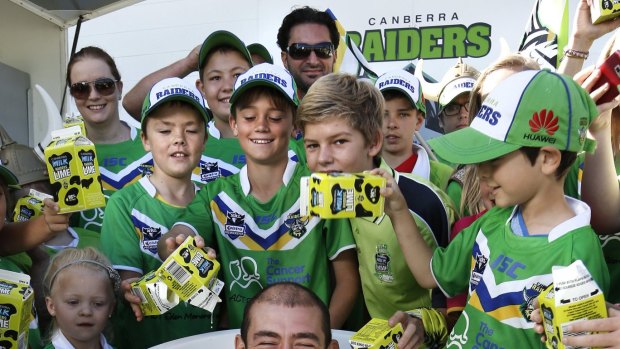 Canberra Raiders fans help give captain Terry Campese a bath of Raiders Lime during the members day at Canberra Stadium in March 2013.