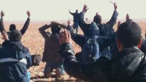 Hostages are seen with their hands in the air at the In Amenas gas facility in this still image taken from video footage taken in January 2013.