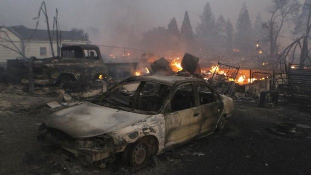 Vehicles and homes are destroyed in Weed, California where a wind-driven wildfire raced through the hillside neighbourhood and forced more than 1000 people to flee the small town near the Oregon border.