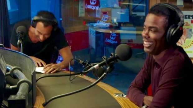 Matt Okine cringes as Chris Rock delights in mocking his comedy during a Triple J interview.