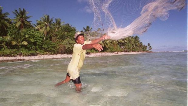 Rising tide: A fisherman throws out his net on the shores of Majuro, Marshall Islands, which is at threat of sea level rises.