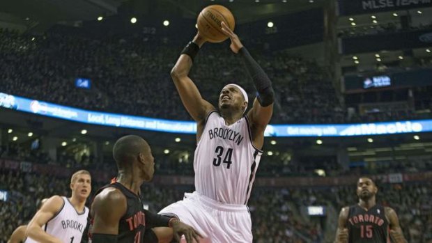 Brooklyn Nets forward Paul Pierce shoots on Toronto Raptors opponent Terrence Ross.