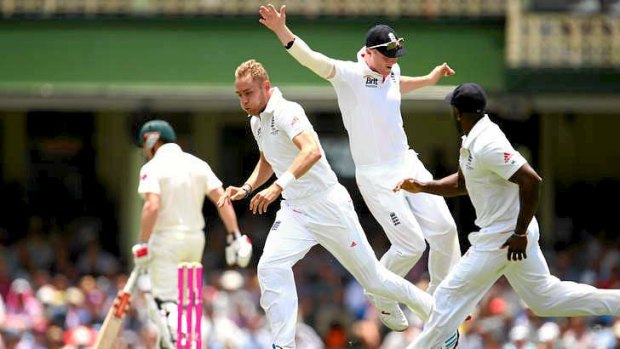 Gone: Stuart Broad of England celebrates taking the wicket of George Bailey.