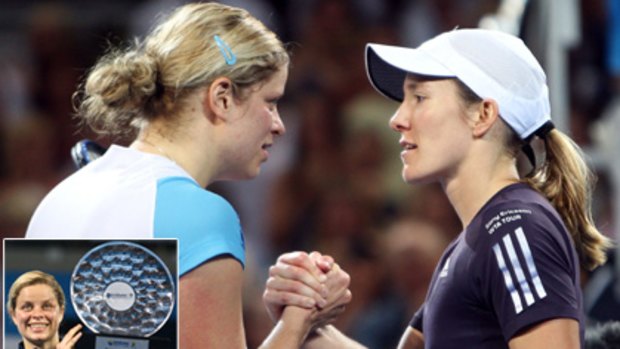 Belgians Kim Clijsters (left) and Justine Henin shake hands at the end of their epic Brisbane International final. INSET: Clijsters with the coveted trophy.
