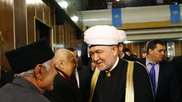 Russia's Grand Mufti Ravil Gainutdin (centre) greets a delegate as they attend the Kurultai, the assembly of Crimea Tatars, in Bakhchisaray.