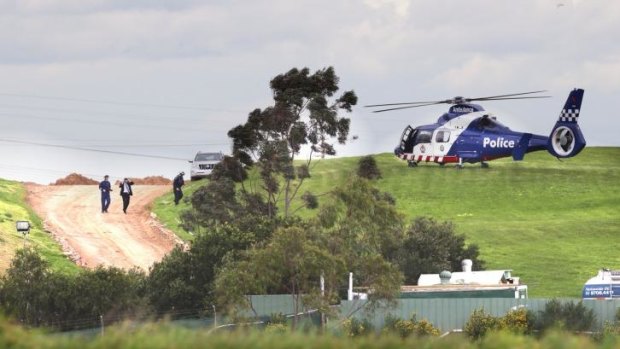 A police helicopter at the landfill site where a body was discovered in Hampton Park.