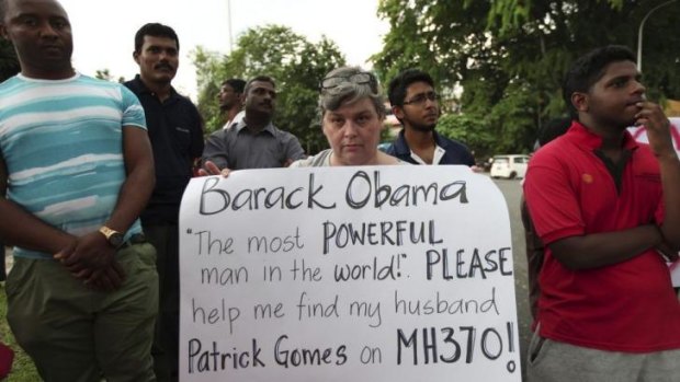A woman holds a sign up before US President Barack Obama's arrival at a talk at the University of Malaya in Kuala Lumpu.