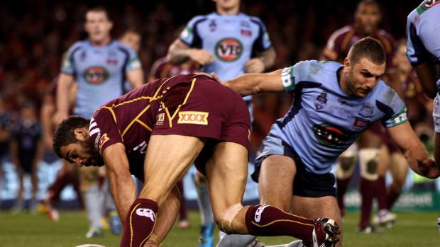 Greg Inglis of the Maroons scores a 'try'.