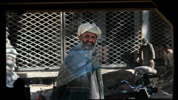 An Afghan stares through the window of a Humvee in central Heret, Afghanistan's third largest city.